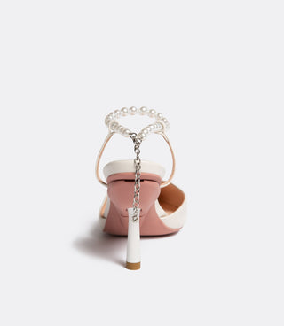 Back view of a white high-heeled sandal with pearl ankle strap and silver chain detail
