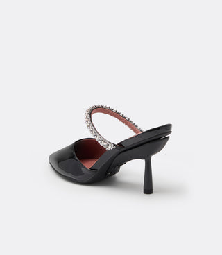 Back three-quarter view of the VICE VERSA Isadora Mule in black patent showing the pink lining