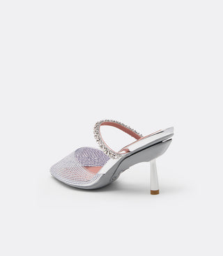 Back three-quarter view of the VICE VERSA Isadora Mule in clear crystal showing the pink lining