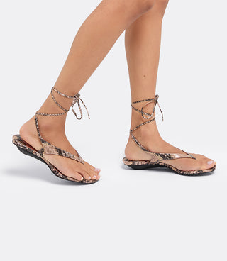 Model wearing the VICE VERSA Margo Sandals in snake print folded into flats