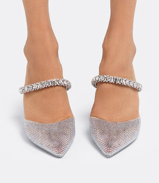 Front view of a model wearing the VICE VERSA Isadora Mules in clear crystal