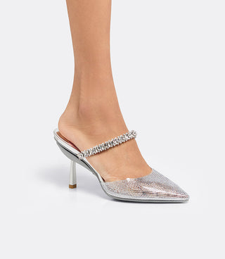 Side view of a model wearing the VICE VERSA Isadora Mule in clear crystal with slim heel