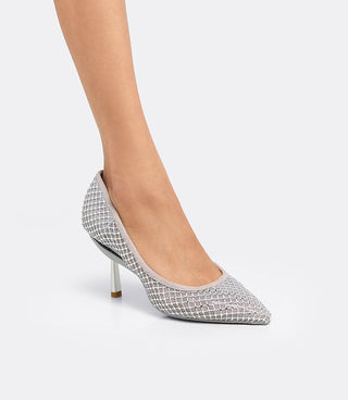 Model wearing the VICE VERSA Ella Pump in silver crystal mesh without the ankle strap, side view