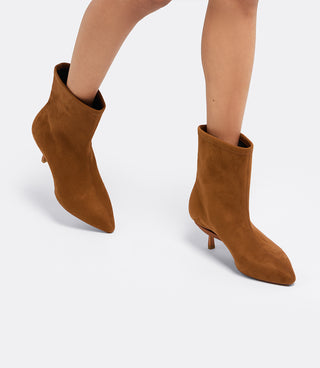 Model walking in the VICE VERSA Bowery Boot in walnut faux suede ankle boots, side view