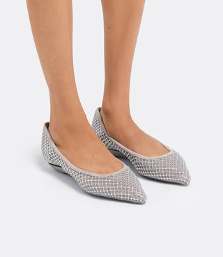 Model wearing the VICE VERSA Ella Pumps in silver crystal mesh folded into flats