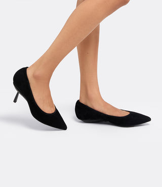 Model walking in the VICE VERSA Ella Pumps in black suede, one in heel mode and one folded flat