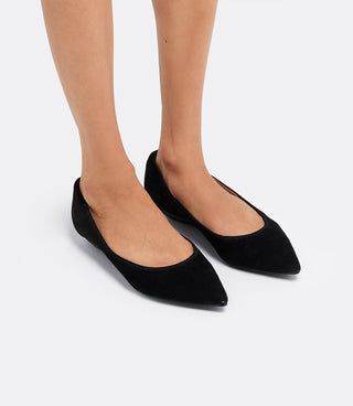 Model wearing the VICE VERSA Ella Pumps in black suede, front three-quarter view