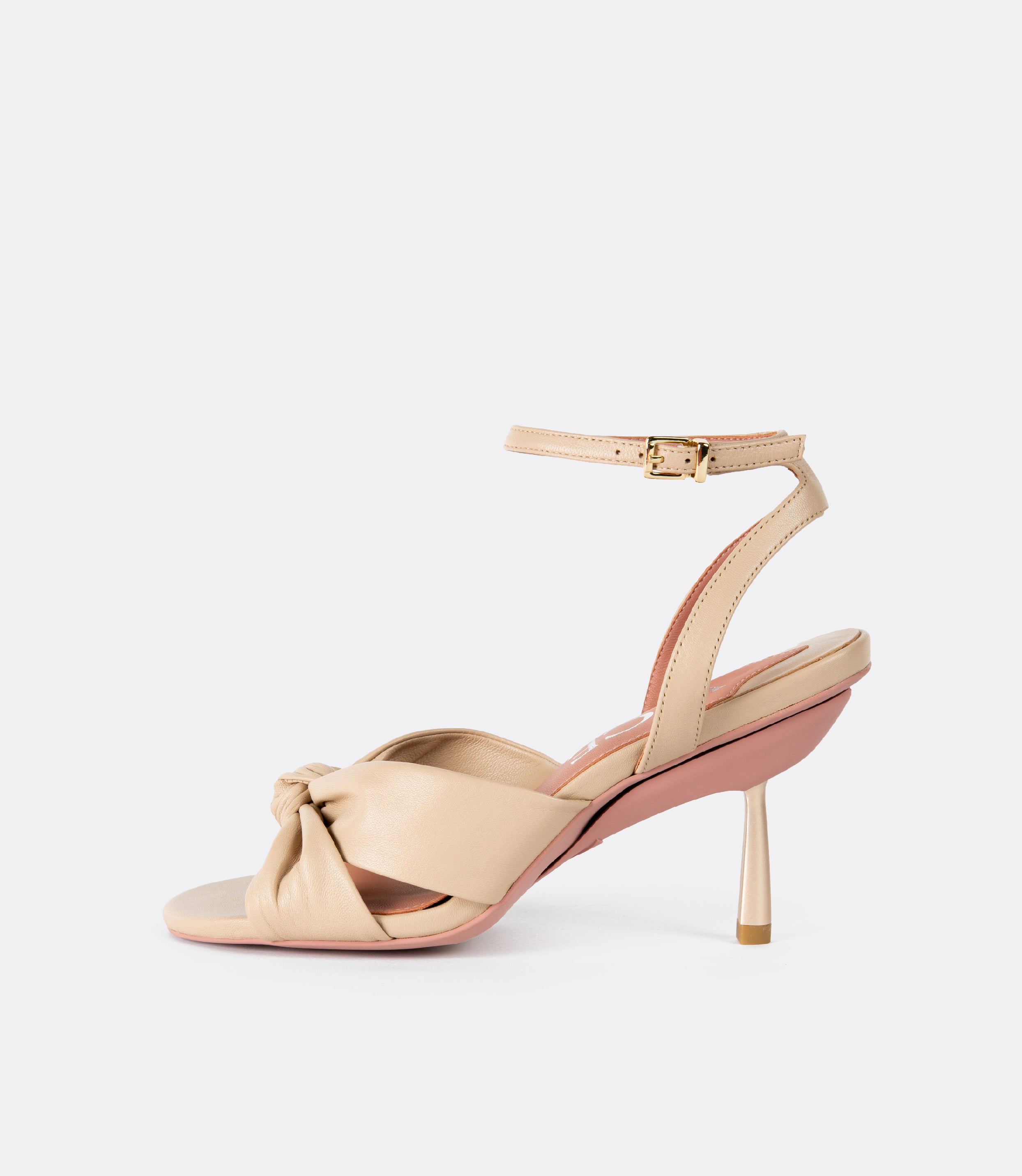 Side view of the beige leather sandals as heels