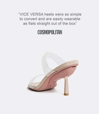 Beige high-heeled shoe with clear strap on a white background, featuring press quote