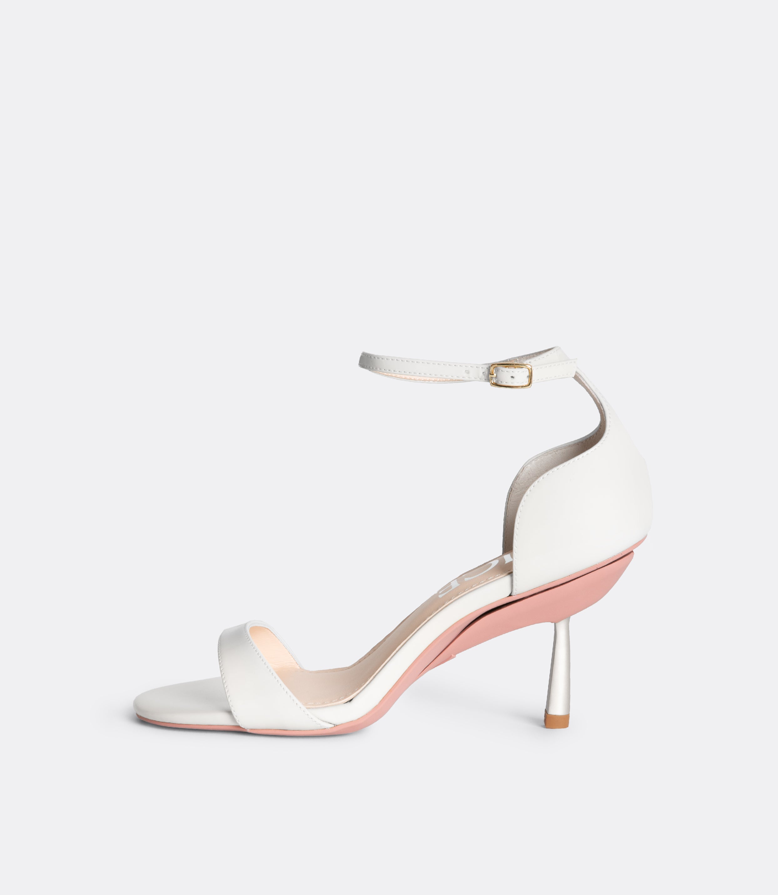Side view of the white editor sandals.