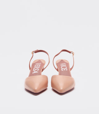 A pair of VICE VERSA pointed-toe slingback heels in a light nude pink leather, shown from the back on a light gray background.