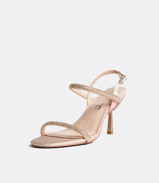 Pink high-heeled sandal with thin straps on a light gray background