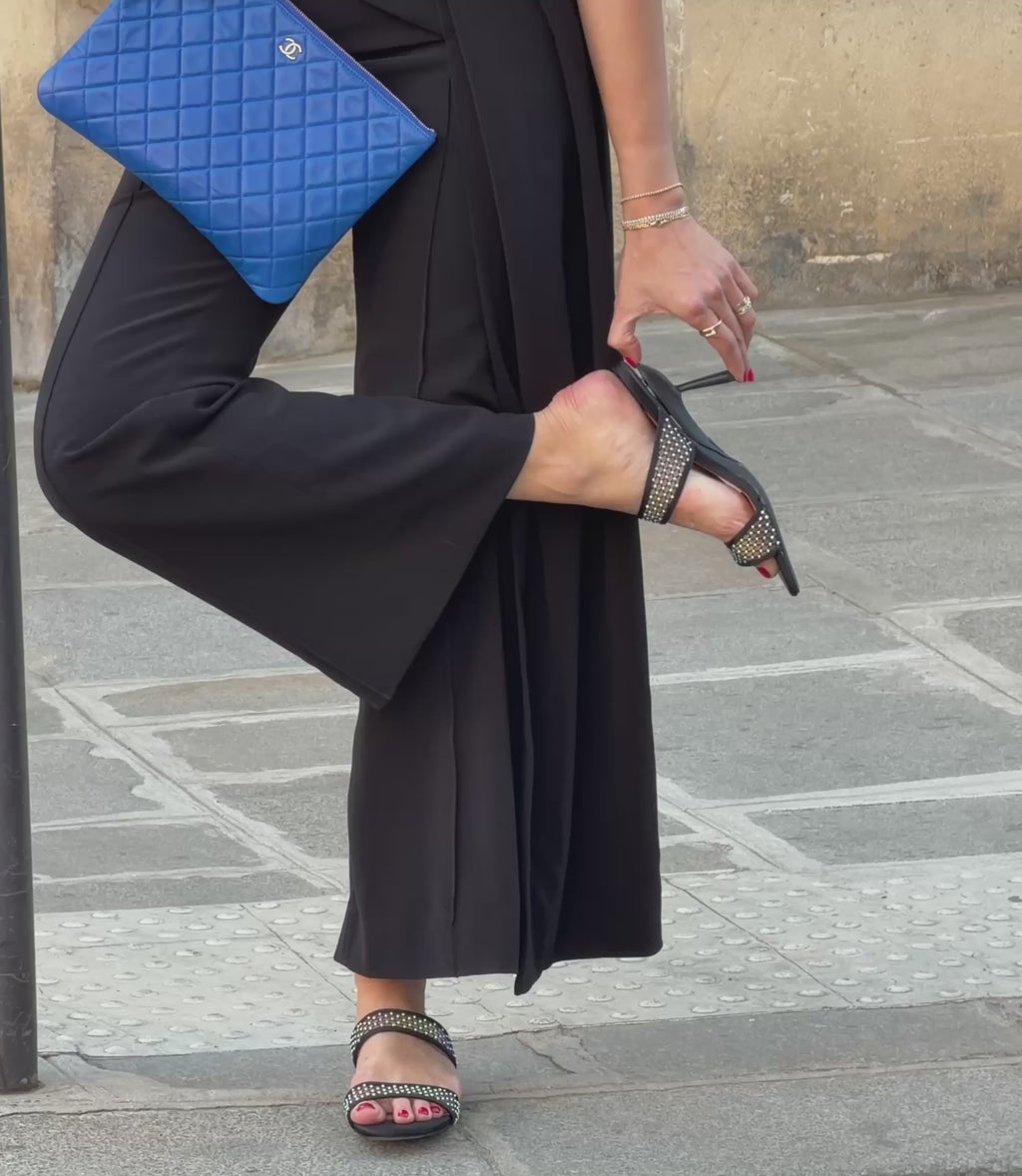 Woman folding Mia convertible heels to a flat