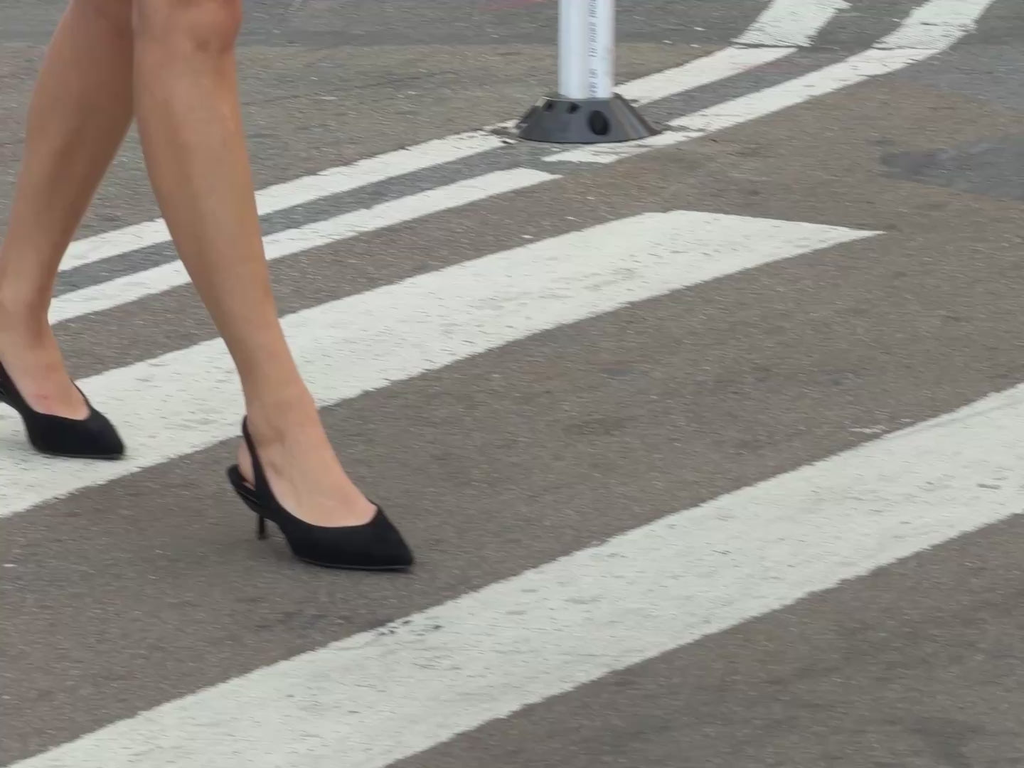Model walking in high heel slingback