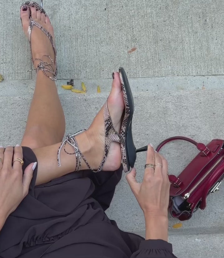 model folding a convertible heel into a flat shoe