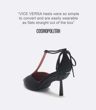 Back view of a black pointed-toe high heel with a T-strap and ankle ties