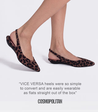 A pair of pointed-toe slingback flats in a brown and black leopard print, shown on a model's feet against a light gray background.