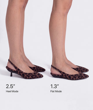 A pair of pointed-toe slingback heels shown on a model's feet against a light gray studio background, with text indicating heel height modes: 2.5" Heel Mode and 1" flat mode