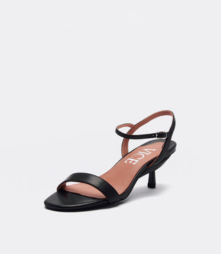 A single black leather sandal with a low kitten heel, featuring a square toe, a thin ankle strap with a buckle, and a dusty pink insole with the brand name 'VICE' printed in white.
