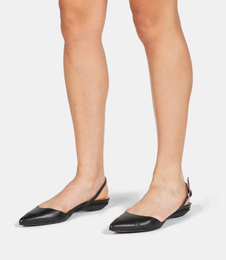 black pointed-toe slingback flat shoes on model's feet